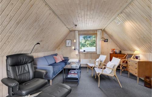 a living room with a blue couch and chairs at Two-Bedroom Holiday Home In Rudkobing in Spodsbjerg