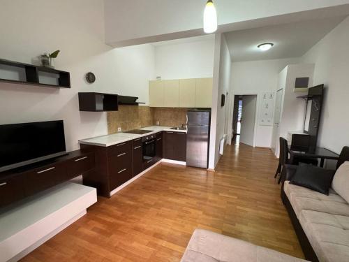 a kitchen and living room with a couch and a table at Apartment Becici Sunset 3 in Becici