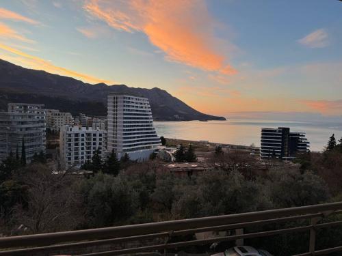 a view of a city with the ocean and buildings at Apartment Becici Sunset 3 in Becici
