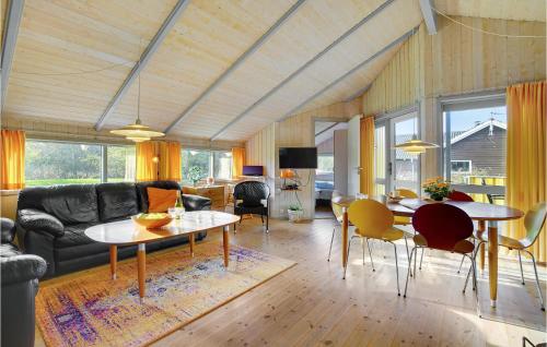 a living room with a couch and a table at Holiday Home Spurvestræde in Dannemare