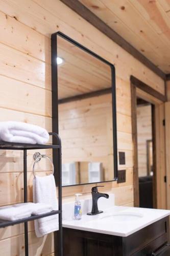 a bathroom with a sink and a large mirror at The NEW Luna Lodge in Broken Bow in Broken Bow