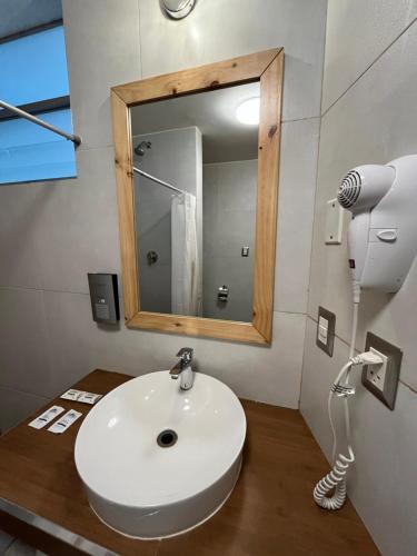 a bathroom with a white sink and a mirror at CASA CRISTOBAL Centenario in Cusco