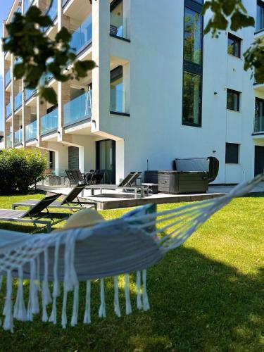 a white bird flying in front of a building at 365Balaton Apartmanok-Garden apartman in Alsóörs