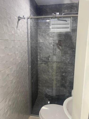 a bathroom with a shower with a toilet and a sink at Hotel Orduz Centro Histórico de Cali in Cali