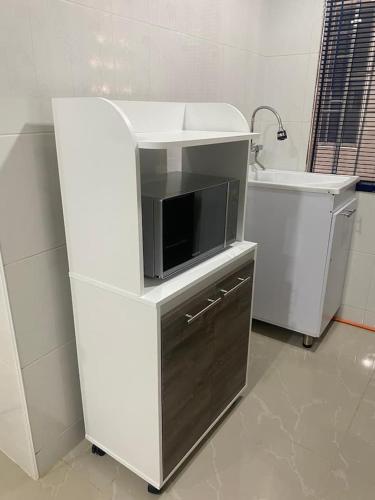 a kitchen with a tv and a sink at Hotel Orduz Centro Histórico de Cali in Cali