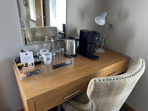 a wooden desk with a mirror and a lamp at The Mitre Inn in Knaresborough