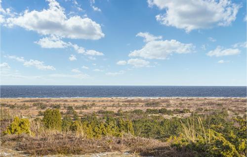 an open field with the ocean in the background at Cosy Home In Anholt With 3 Bedrooms And Wi-Fi in Anholt