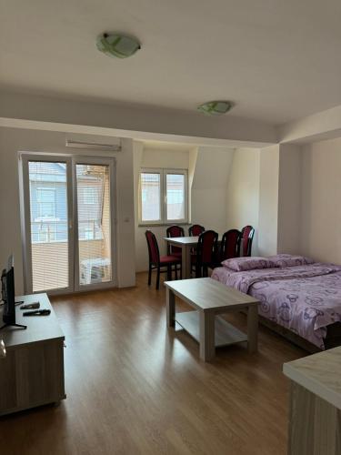 ein Schlafzimmer mit einem Bett, einem Tisch und Stühlen in der Unterkunft Aleksandra in Ohrid