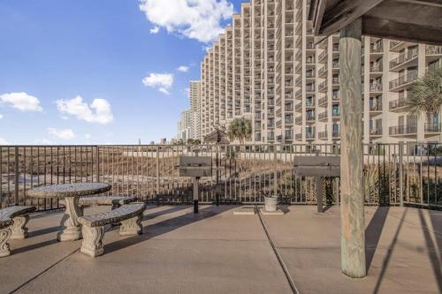 a group of benches in front of a large building at Phoenix VIII-8206 by Vacation Homes Collection in Orange Beach