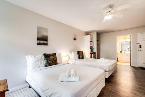 a bedroom with two beds with towels on them at Muskoka Waterfront Retreat in Dwight