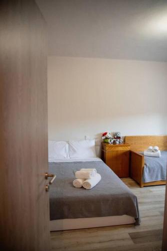 a bedroom with a bed with towels on it at Betty's 4 Seasons in Agria in Agria