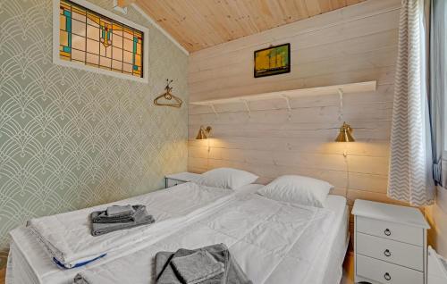 a small bedroom with a bed with white sheets at Awesome Home In Kalundborg With Wifi in Kalundborg