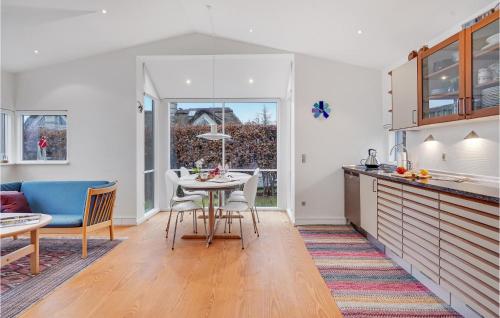 a kitchen and dining room with a table and chairs at Amazing Home In Nyborg With Kitchen in Nyborg