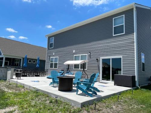 a patio with chairs and a table in front of a building at Gorgeous Seaside Paradise - Ultimate Family Getaway! in Ocean View