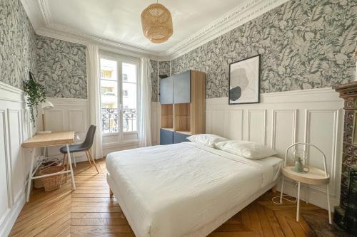 a bedroom with a bed and a desk in it at Flexliving - room - Hameau in Paris