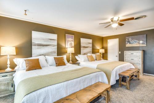 a bedroom with two beds and a ceiling fan at Remote Texas Retreat Hot Tub, Deck, Grill! in Dalhart