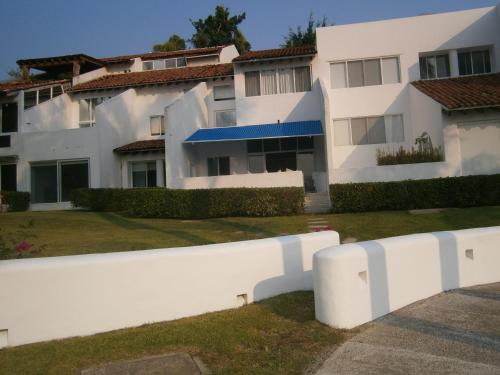a white fence in front of a building at Villa Marina Porto Ixtapa in the Private Yacht Club in Ixtapa