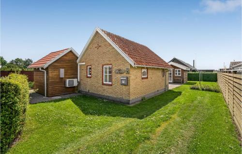 a house with a grass yard in front of it at Two-Bedroom Holiday Home In Otterup in Otterup