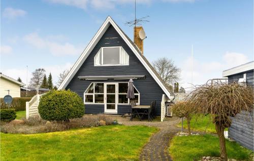 a black house with a pitched roof at Three-Bedroom Holiday Home In Otterup in Otterup