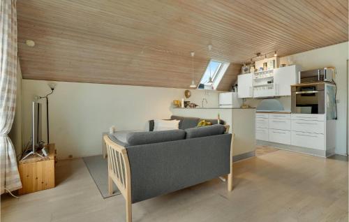a living room with a couch and a kitchen at Three-Bedroom Holiday Home In Otterup in Otterup