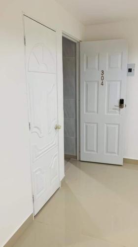 an empty room with a white door and white floors at Hotel Orduz Centro Histórico de Cali in Cali