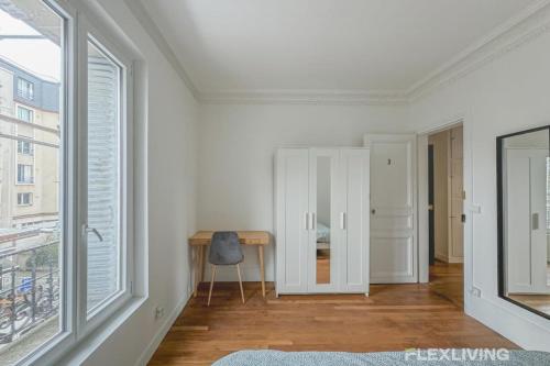 Cette chambre blanche dispose d'un bureau et d'une fenêtre. dans l'établissement Flexliving - Room - Henri Sellier - Suresnes 92, à Suresnes
