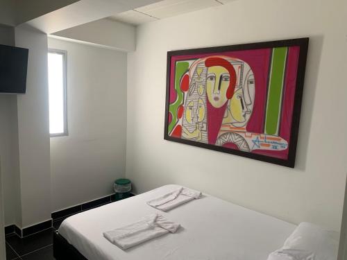 En eller flere senge i et værelse på Hotel Lindbergh Quindio