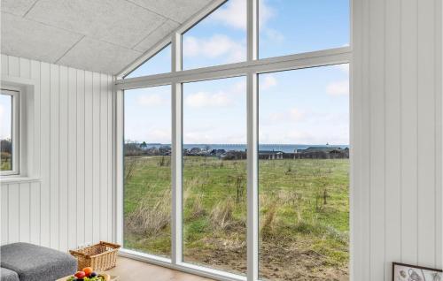 a room with a large window looking out at a field at Nice Home In Frørup With Kitchen in Tårup
