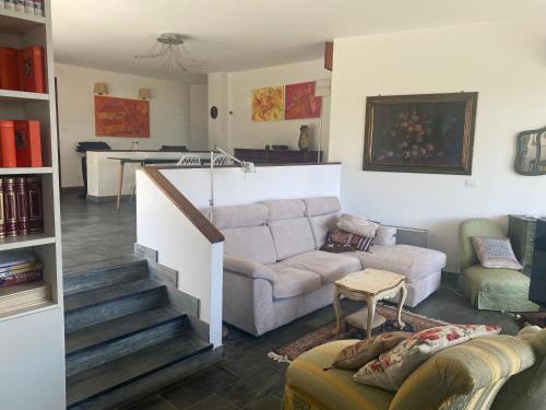 a living room with a couch and a staircase at Villa Gioia in Celle Ligure