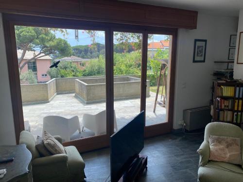 a living room with a large sliding glass door at Affitti Brevi Liguria - Villa Gioia in Celle Ligure