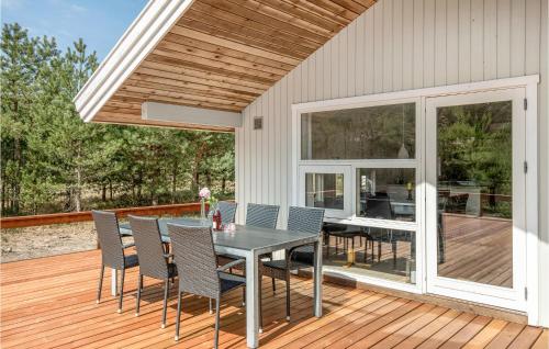 a patio with a table and chairs on a deck at Beautiful Home In Nexø With Kitchen in Neksø