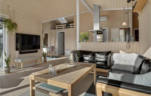 a living room with a couch and a table at 3 Bedroom Nice Home In Haarby in Hårby