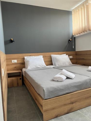 a bedroom with a bed with two towels on it at PROTERM apartments in Timjanik