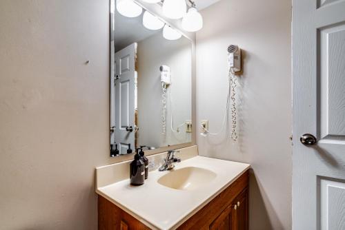 a bathroom with a sink and a mirror at Muskoka Waterfront Retreat in Dwight