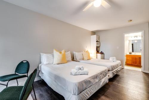 a bedroom with two beds and a chair in it at Muskoka Waterfront Retreat in Dwight