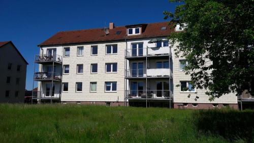 a large white building with a red roof at Wohnung in Lelkendorf mit Großem Balkon - b48801 in Lelkendorf