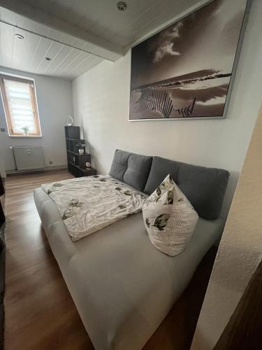 a large bed in a room with at Grünes Haus Dornburg in Dornburg