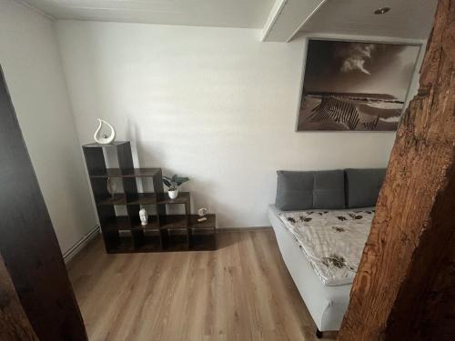 a living room with a bed and a table at Grünes Haus Dornburg in Dornburg