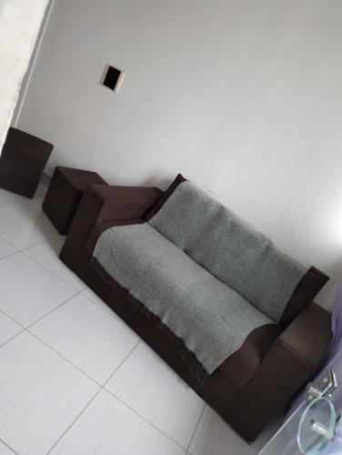 a couch sitting in a living room with at Casa in Campina Grande