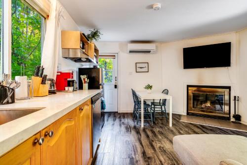 a kitchen with a fireplace and a table with chairs at Muskoka Waterfront Retreat in Dwight