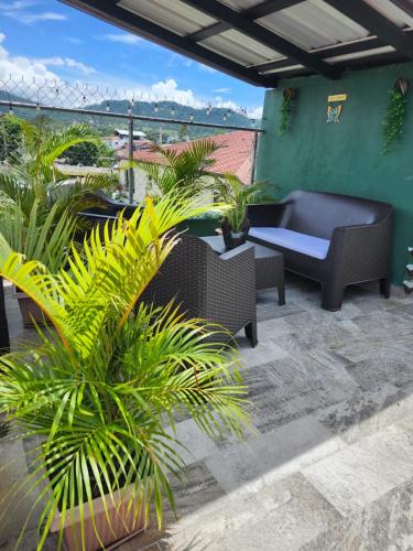 a patio with a couch and some plants at Lovely tiny studio in Jarabacoa
