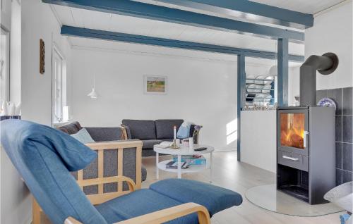a living room with a fireplace and a couch at Fodermesterhuset in Gudhjem