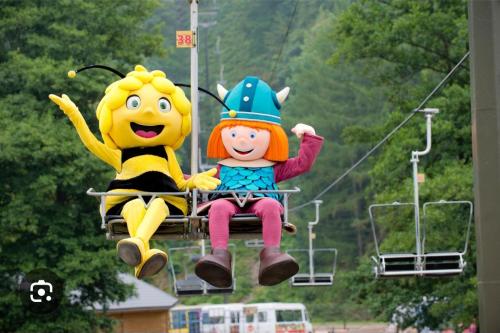 a group of people riding on a ski lift at Le petit Écrin, caravane résidentielle in Trois-Ponts
