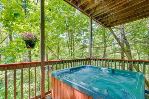 a hot tub on the deck of a house at Smoky Mountain Cabin with Deck and Hot Tub! in Pigeon Forge