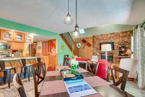 a dining room and kitchen with a table and chairs at Smoky Mountain Cabin with Deck and Hot Tub! in Pigeon Forge