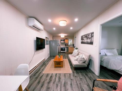 a small living room with a bed and a couch at Muskoka Waterfront Retreat in Dwight