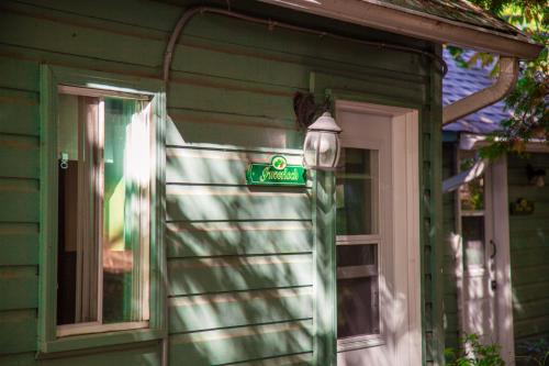 a green house with a sign on the side of it at Muskoka Waterfront Retreat in Dwight
