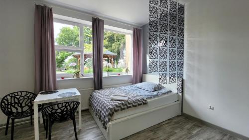 a small bedroom with a bed and a window at Apartamenty Parkowe nr 2 in Kwidzyn