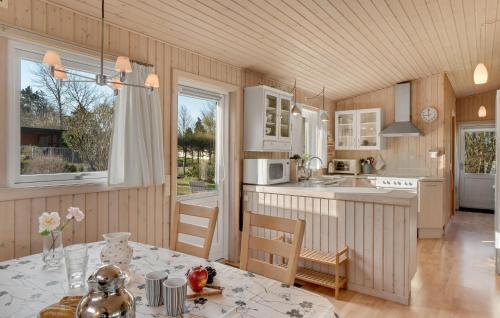 a kitchen with a table and a dining room at Lovely Home In Melby With Kitchen in Melby