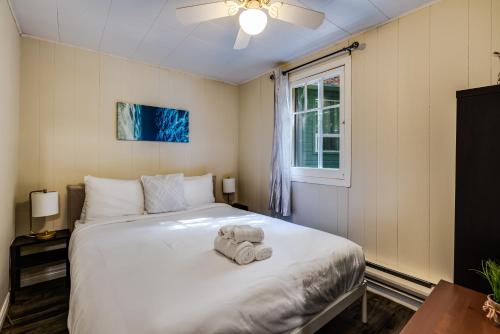 a bedroom with a bed with an elephant toy on it at Muskoka Waterfront Retreat in Dwight